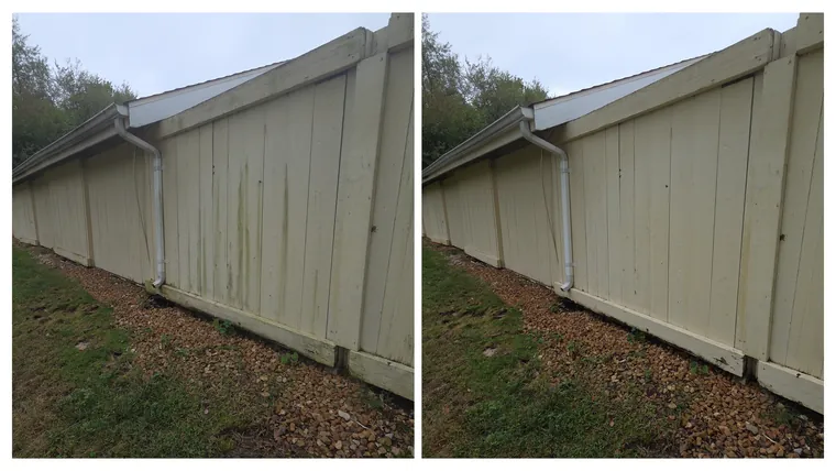 Before and after: dark algae streaks cleaned off the painted board wall of a long outbuilding
