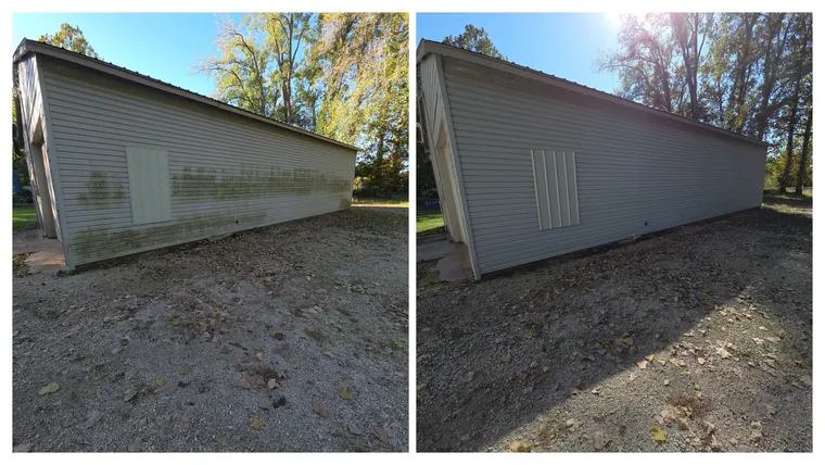 Before and after: heavy green algae soft washed off the grey vinyl siding of a long outbuilding