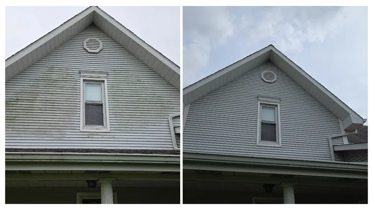 Before and after: an algae-darkened farmhouse gable washed back to clean grey siding