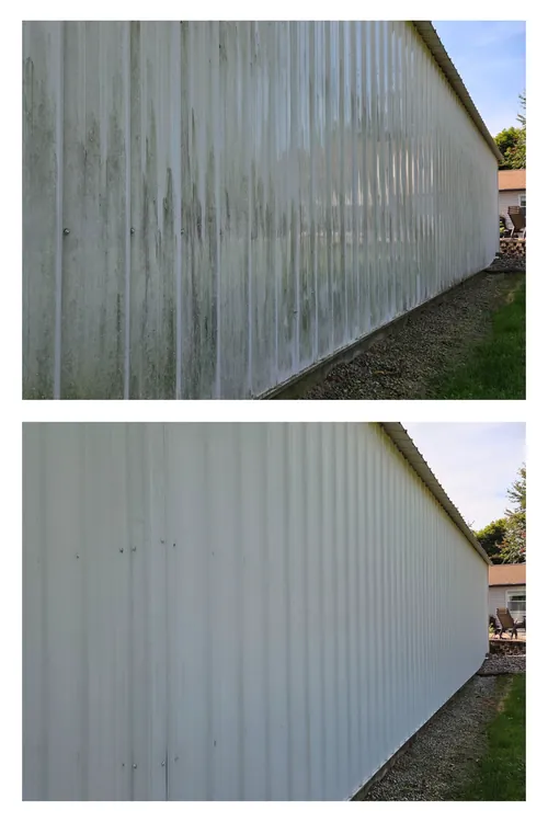 Before and after: the full length of a pole barn wall, its green streaking soft washed away