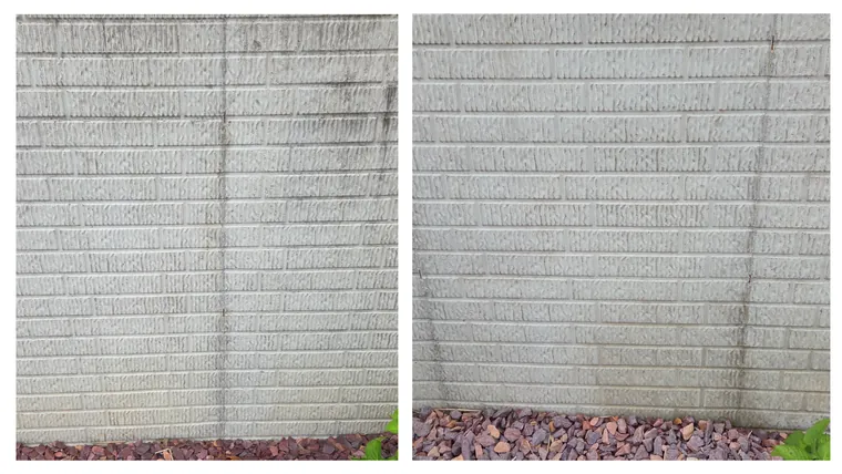 Before and after: an algae-shadowed corner of a block wall above red landscape rock, cleaned