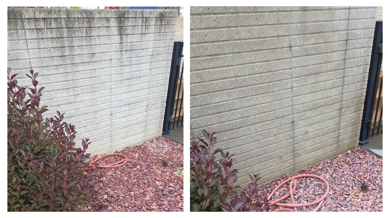 Before and after: dirt and algae streaks washed off a concrete block wall